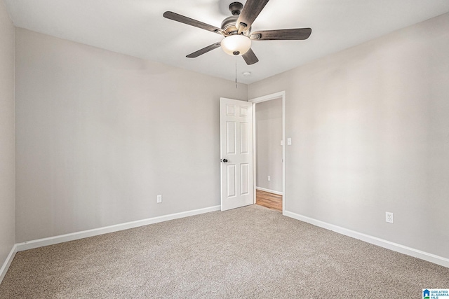 spare room featuring carpet flooring and ceiling fan