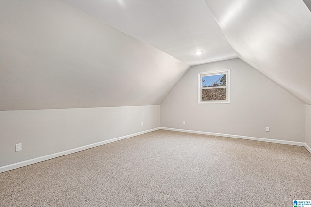 bonus room with carpet flooring and lofted ceiling