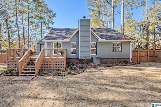 back of house with a wooden deck and central AC