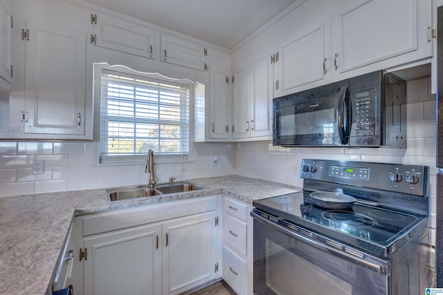 kitchen with backsplash, sink, white cabinets, and black appliances