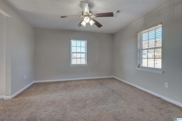 unfurnished room with carpet flooring, a textured ceiling, and ceiling fan