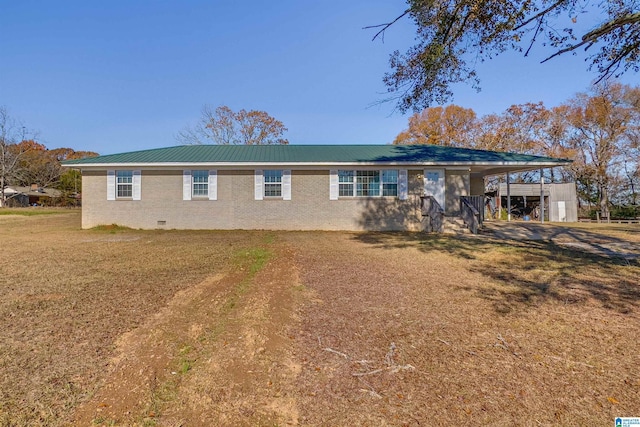 single story home featuring a front lawn and a carport