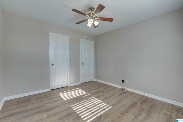 unfurnished bedroom featuring ceiling fan and light hardwood / wood-style flooring