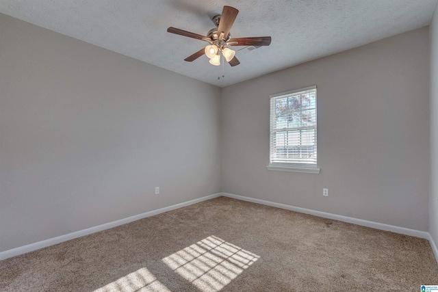 unfurnished room featuring carpet, a textured ceiling, and ceiling fan