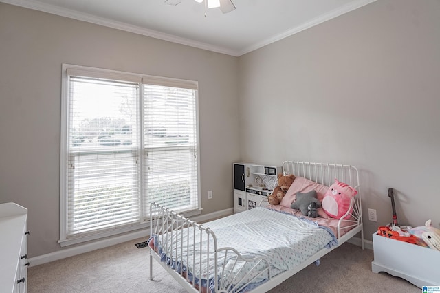 carpeted bedroom with ceiling fan and crown molding