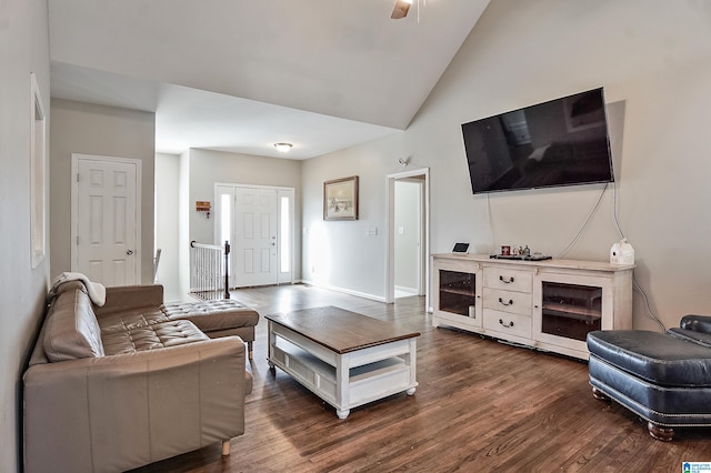 living room featuring ceiling fan, dark hardwood / wood-style flooring, and lofted ceiling