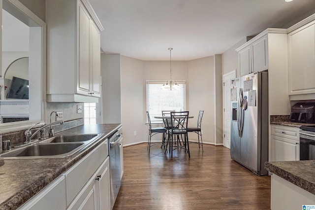 kitchen with white cabinetry, sink, stainless steel appliances, dark hardwood / wood-style flooring, and pendant lighting