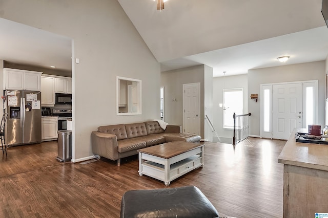 living room with dark hardwood / wood-style flooring and high vaulted ceiling