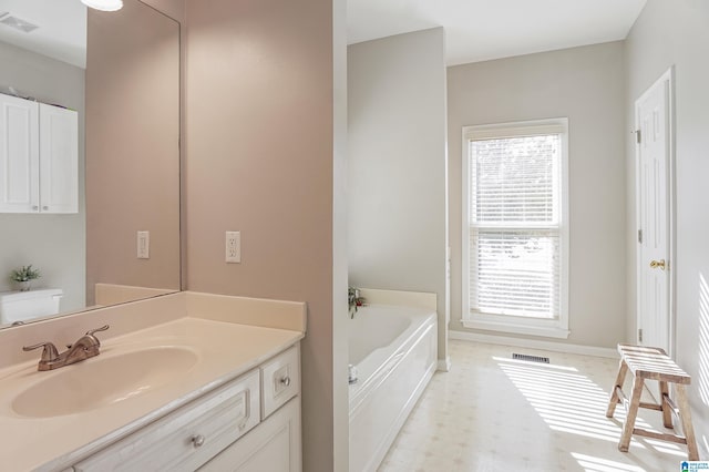 bathroom featuring vanity, toilet, and a bathtub