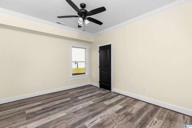 spare room featuring ceiling fan, dark hardwood / wood-style flooring, and crown molding