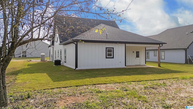 back of property featuring a yard and central AC unit