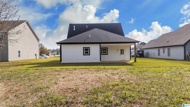 back of property with a lawn