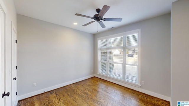 spare room with hardwood / wood-style flooring and ceiling fan