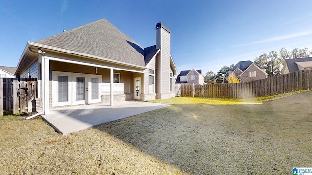 rear view of property with french doors and a patio