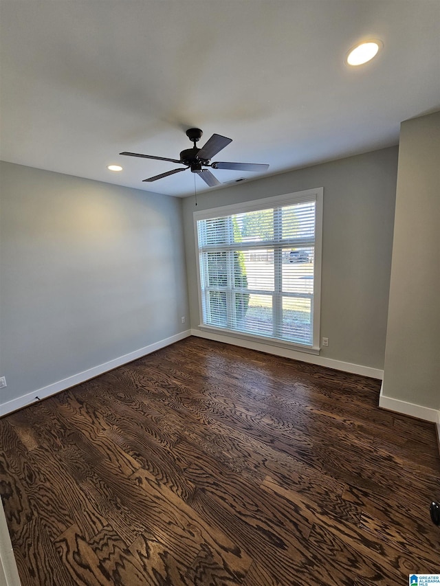 unfurnished room with ceiling fan and dark hardwood / wood-style flooring