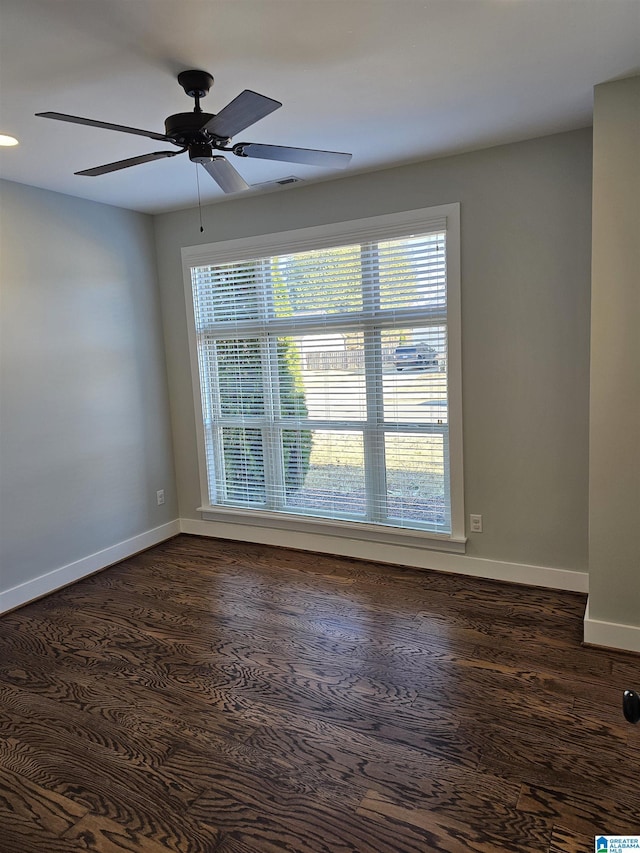 spare room featuring dark hardwood / wood-style floors and ceiling fan