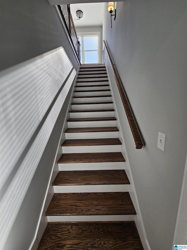 stairs featuring hardwood / wood-style floors