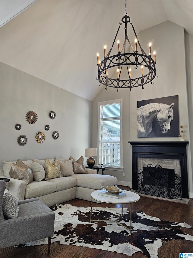 living room with a high end fireplace, wood-type flooring, and vaulted ceiling