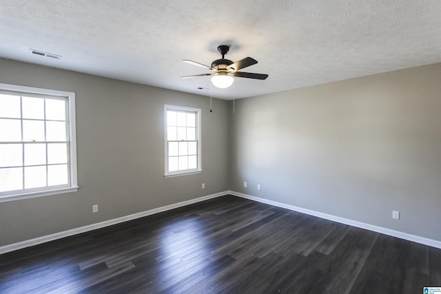 spare room with ceiling fan, dark hardwood / wood-style flooring, and a textured ceiling