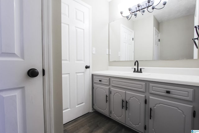 bathroom featuring vanity, wood-type flooring, and a textured ceiling