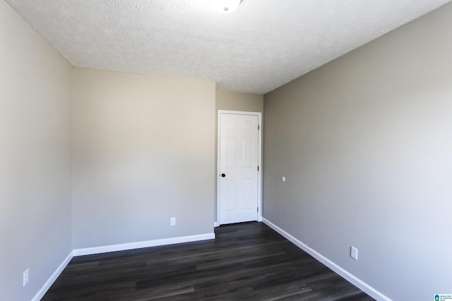 unfurnished room featuring a textured ceiling and dark wood-type flooring