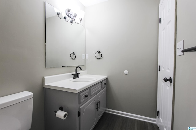 bathroom featuring hardwood / wood-style flooring, vanity, and toilet