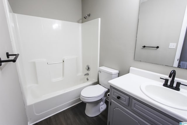 full bathroom with hardwood / wood-style floors, vanity, toilet, and shower / washtub combination