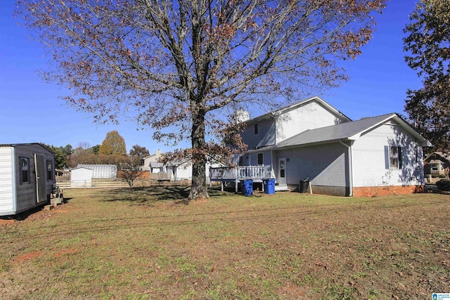 view of yard with a deck and a storage unit