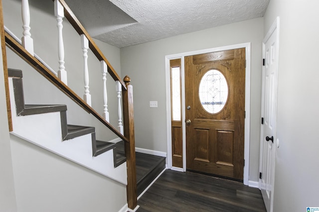 foyer featuring dark hardwood / wood-style flooring and a textured ceiling