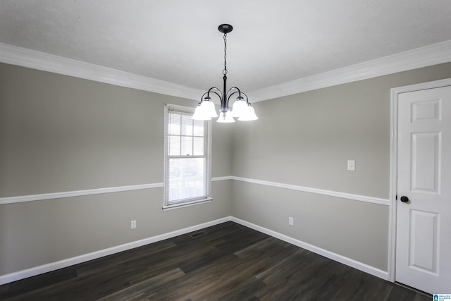 empty room featuring a chandelier, dark hardwood / wood-style floors, and ornamental molding