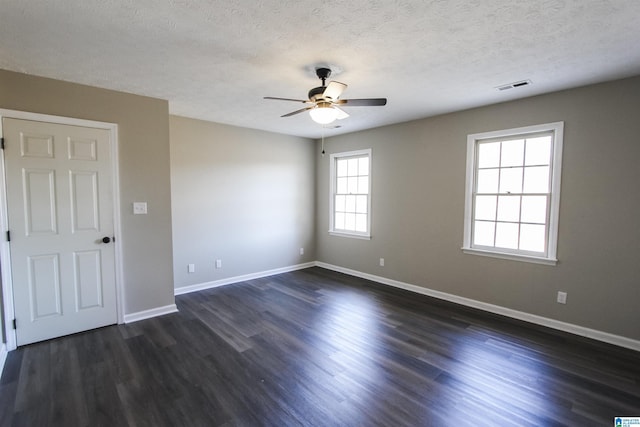 unfurnished room featuring a textured ceiling, ceiling fan, and dark hardwood / wood-style floors