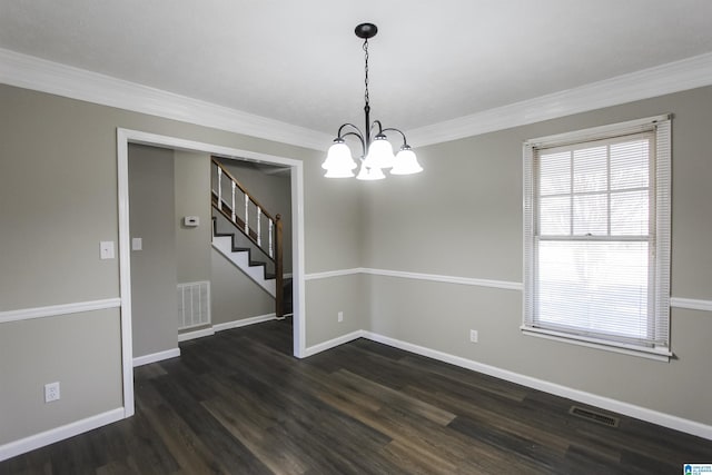 unfurnished dining area featuring dark hardwood / wood-style flooring, crown molding, and a notable chandelier