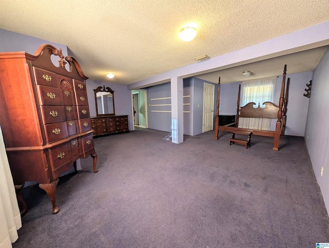 living area with dark carpet and a textured ceiling