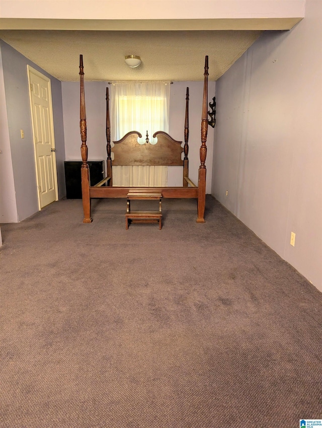 bedroom with a textured ceiling and carpet floors