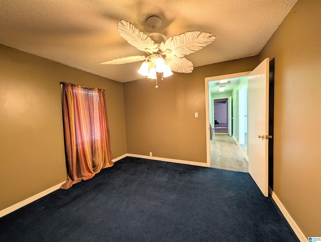 carpeted empty room featuring a textured ceiling and ceiling fan