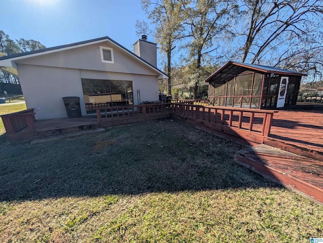 exterior space featuring a sunroom and a wooden deck