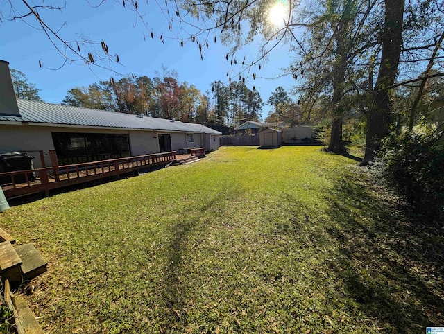 view of yard with a storage shed and a deck