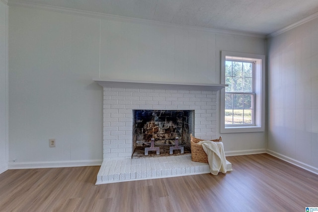 room details with a fireplace, hardwood / wood-style floors, a textured ceiling, and ornamental molding