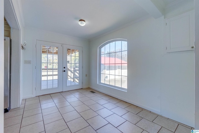 entryway featuring french doors, crown molding, and light tile patterned flooring