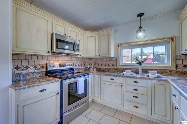 kitchen featuring decorative backsplash, appliances with stainless steel finishes, hanging light fixtures, and light tile patterned flooring