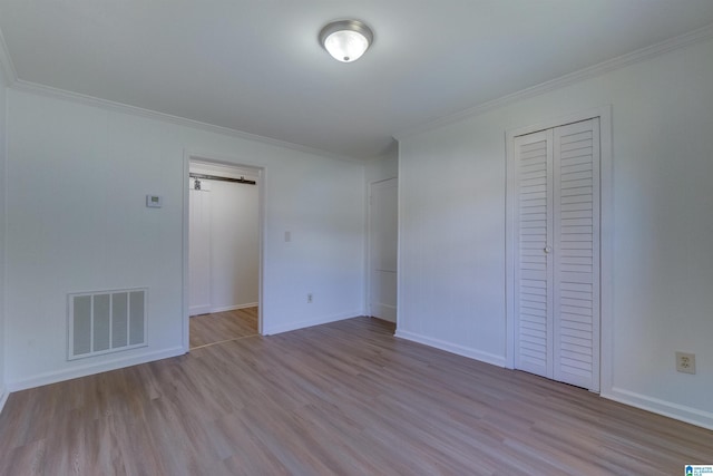 unfurnished bedroom with light hardwood / wood-style floors and crown molding