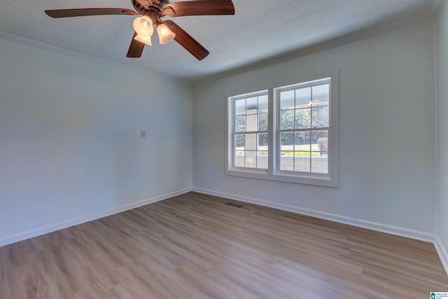 empty room with a textured ceiling, light hardwood / wood-style floors, ceiling fan, and ornamental molding