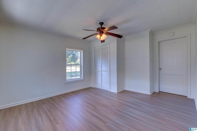 unfurnished room with ceiling fan, crown molding, light hardwood / wood-style floors, and a textured ceiling