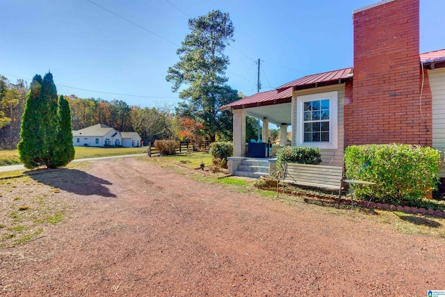 view of side of property with covered porch