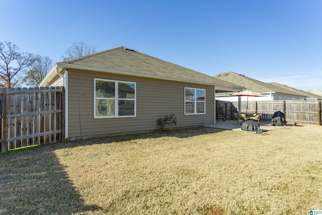 back of property with a lawn and a patio