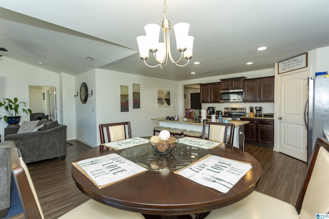 dining space featuring vaulted ceiling, a chandelier, and dark hardwood / wood-style floors