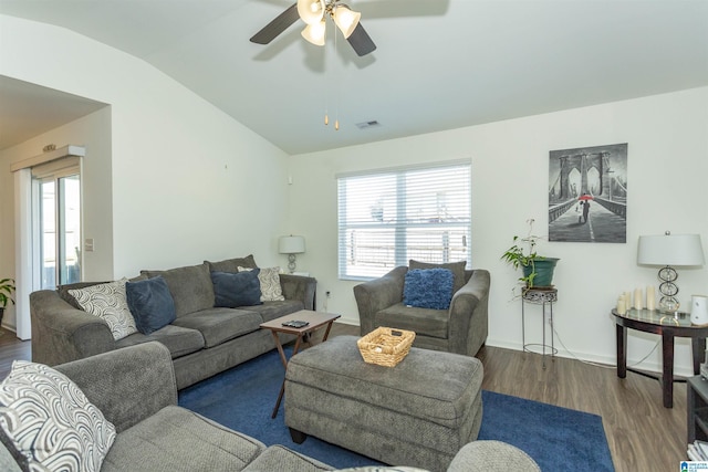 living room featuring a healthy amount of sunlight, dark hardwood / wood-style flooring, ceiling fan, and lofted ceiling