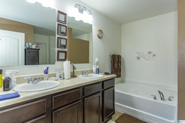 bathroom featuring vanity and a tub