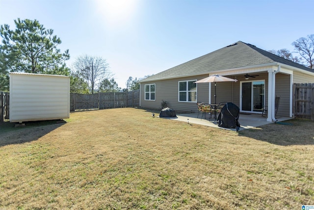 view of yard featuring ceiling fan and a patio