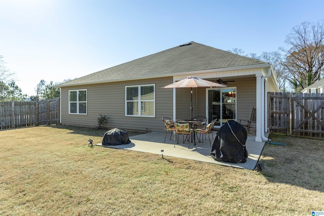 rear view of property with a yard and a patio